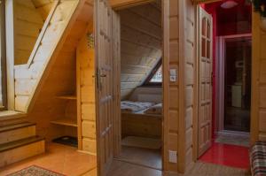 a room in a log cabin with a bed at Willa Jafer - Zakopane Centrum in Zakopane