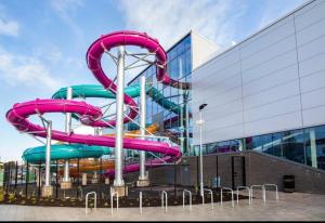 a water slide in front of a building at Unique Belfast Stay in Belfast