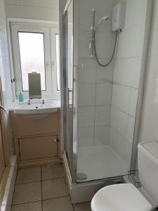 a bathroom with a shower and a toilet and a sink at FREE Extra Guest. Heart of Birmingham City Centre in Birmingham