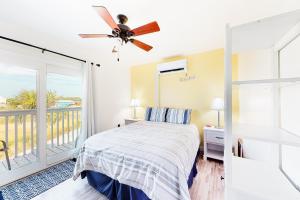 a bedroom with a bed and a balcony at Fort Morgan Townhomes E1 in Fort Morgan +21 photos