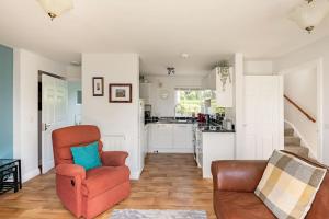 a living room with a couch and a chair at Ty Venda in Pembrokeshire