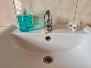 a bathroom sink with a bottle of water and a soap at Adega do Costa in Prainha de Baixo +2 photos
