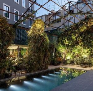 a courtyard with a pool in a building at Hotel X Hotel Avenida Liberdade, a Member of Design Hotels in Lisbon