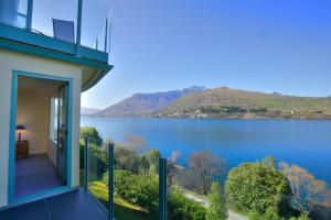 a house with a view of a lake at Frankton House - Queenstown Holiday Home in Queenstown