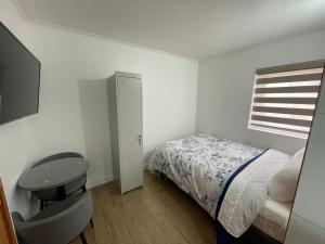 En eller flere senger på et rom på TinyApartments - estudio pleno centro Concepción