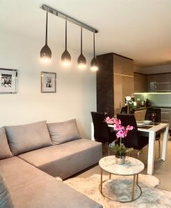 a living room with a couch and a table at Downtown Apartments Monroe in Rzeszów