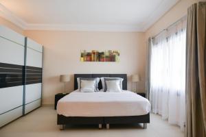 a bedroom with a large bed and a window at Atlantic Luxury Apartments in Bakau