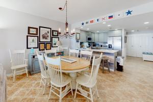 a kitchen and dining room with a table and chairs at The Beach Bounce in Pensacola Beach