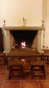 a fireplace with a table with a fire in it at LAS PIÑONERAS in Tórtoles