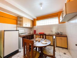 a small kitchen with a table and a refrigerator at Casa Abaroa in La Paz