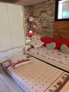 a bedroom with a large bed with a red headboard at at foot of Mont Blanc studio 2 p in Cluses