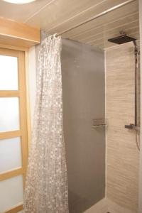 a shower curtain in a bathroom with a window at at foot of Mont Blanc studio 2 p in Cluses