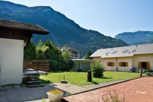 a yard with two houses and mountains in the background at at foot of Mont Blanc studio 2 p in Cluses