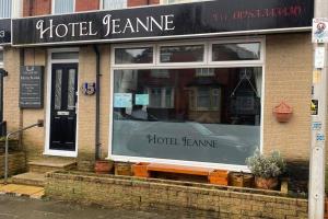 a store front with a window on a street at JEANNE in Blackpool
