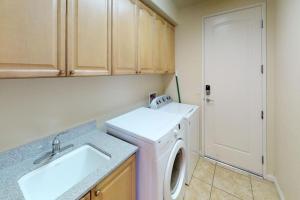 a laundry room with a washing machine and a sink at LV305 Legacy Villas Townhome w Expansive Patio in La Quinta +35 photos