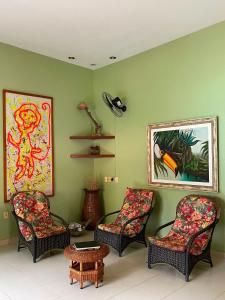 a living room with three chairs and a table at Beloalter Hotel in Alter do Chao