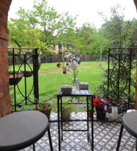 a patio with a table and chairs and a garden at Lovely 2 bed Hampstead Apartment in London