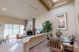 a dining room and living room with a table and chairs at PGA306 Roomy Single Story PGA West 3 Bedroom in La Quinta
