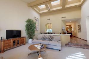a living room with a couch and a tv at PGA306 Roomy Single Story PGA West 3 Bedroom in La Quinta