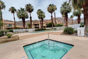 a swimming pool in the middle of a courtyard with palm trees at PGA306 Roomy Single Story PGA West 3 Bedroom in La Quinta