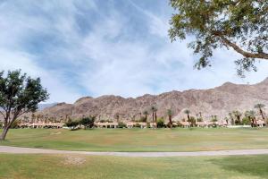 a golf course with a mountain in the background at PGA306 Roomy Single Story PGA West 3 Bedroom in La Quinta