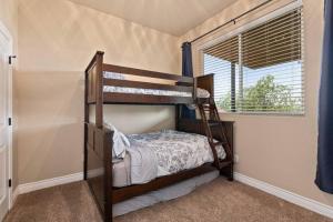 a bedroom with two bunk beds and a window at Lakeview Villa-we have boat rentals too! in Canyon Lake