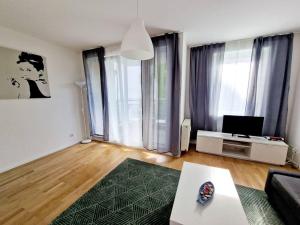 a living room with a couch and a tv at Apartment in the heart of Berlin 2122 in Berlin