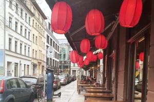 a row of red lanterns hanging from a building at Apartment in the heart of Berlin 2122 in Berlin