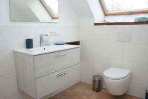 a bathroom with a sink and a toilet at Ferienwohnung Die Paradiesische in Kleve +9 photos