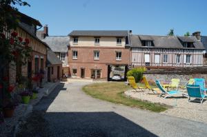 a group of lawn chairs in front of a building at LE SECHOIR DANTAN in Doudeville