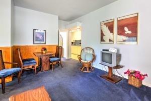 un soggiorno con TV, sedie e tavolo di Vintage Galveston Apt Less Than half Mi to Porretto Beach! a Galveston