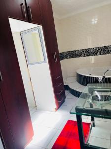 a bathroom with a toilet and a sink and a tub at Bloom Guest House in Pretoria