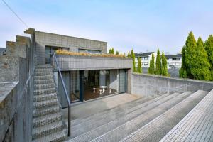 a house with a staircase leading up to a building at BRUCE HOUSE - Vacation STAY 9370 in Izumi-Sano