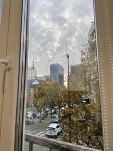 a view from a window of a city street with cars at Duplex situé a 2min de la gare du nord in Brussels