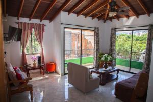 a living room with large windows and a couch at Apartamento en Envigado in Envigado