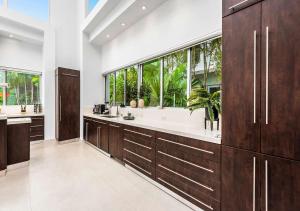 a bathroom with wooden cabinets and a large window at Exotic 5 Bedroom Villa In South Miami in Miami
