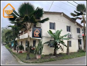 a building with a sign on the side of it at Bed and Breakfast La Casa Naranja in Olón