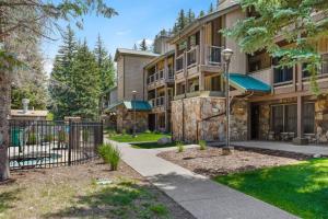 an apartment building with a gate and a yard at Bluegreen's StreamSide at Vail in Vail