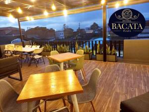 a restaurant with tables and chairs and a sign that reads babka taco at Hotel Bacata Plaza in Zipaquirá