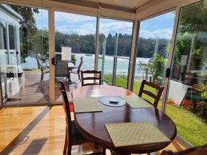 a table and chairs on a porch with a view of the water at A Slice of Paradise in Barnes Bay