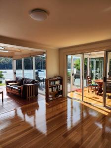 a living room with a couch and a table at A Slice of Paradise in Barnes Bay