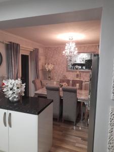a kitchen and dining room with a table and chairs at Liverpool Air b and b in Sefton