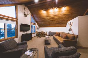 a living room with a couch and chairs and a tv at Teton Teepee Lodge in Alta