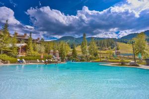 a large pool of blue water in a resort at Aurora Townhomes by StayIn in Panorama