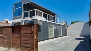 een huis met een garage en een hek bij Marco Zero Containers 2 in Balneário Camboriú