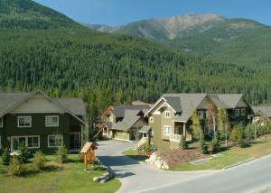 an aerial view of a house with mountains in the background at Aurora Townhomes by StayIn in Panorama