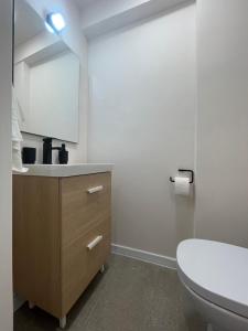 a bathroom with a sink and a toilet and a mirror at Apartament Mony in Timişoara
