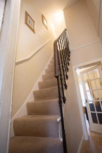 a staircase in a house with a stair case at Sandgate 2-Bed Apartment in Ayr central location in Ayr