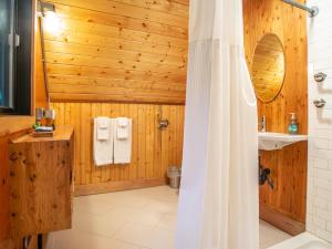 a wooden bathroom with a shower and a toilet at Treetop Hideaway, Sleeps 2 in Glacier +17 photos