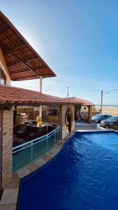 a large swimming pool in a house with a building at Pousada Casa Do Alemão in Flecheiras